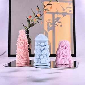 Macro detail of textured pillar candle molds with relief patterns on a mirror base