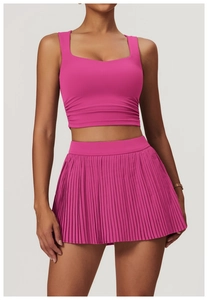 Close-up of red pleated sports skirt and U-neck tank top in high-elastic fabric