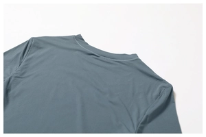 Detailed close-up of crew neckline and double-needle stitching on yoga top fabric