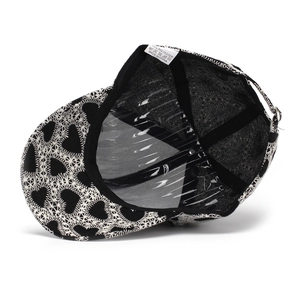 Detail of baseball cap interior showing black lining, sweatband and heart embroidery