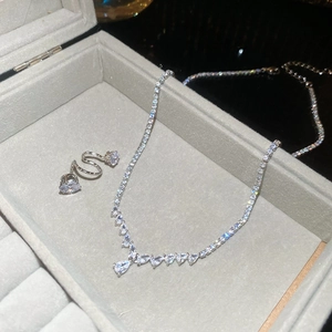Detail of silver zirconia necklace and screw-on earrings in a grey velvet gift box