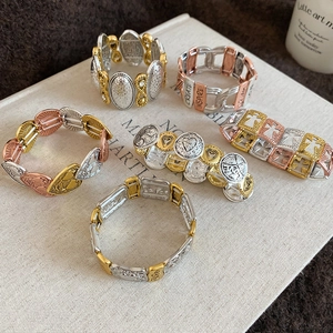 Detailed close-up of bohemian elastic bracelets with heart and dream engravings