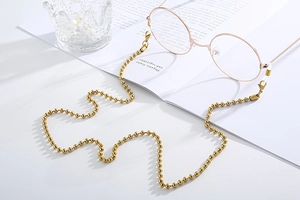 Detailed view of gold beaded titanium steel sunglasses chain with silicone non-slip ends