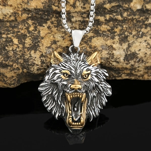 Nordic Viking wolf head pendant necklace in silver and gold steel on a dark stone background