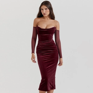 Detail of burgundy velvet dress with ruched texture and sheer mesh long sleeves
