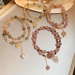 Detail of multi-layer freshwater pearl bracelets with natural crystals and shell accents