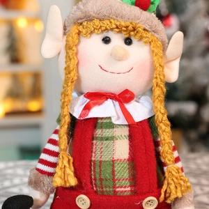 Close-up of a Christmas elf doll featuring yellow braids and green plaid shirt details