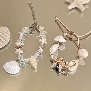 Handmade seashell and pearl bracelets set with starfish charms for beach vacations