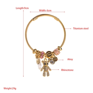 Detail view of titanium steel charm bracelet with rhinestone bear and pink enamel bead charms