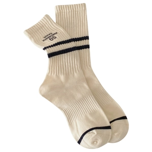 Off-white cotton crew socks with blue stripes and embroidered letters in minimalist style