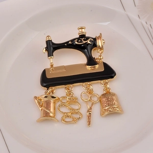 Detail of vintage sewing machine brooch with scissors, tape measure, and spool charms