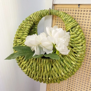 Handwoven green corn rope wall hanging basket with artificial peony flowers for home decor