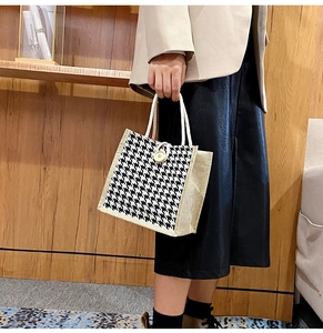 Close-up of houndstooth canvas tote bag with wooden button and cotton rope handle