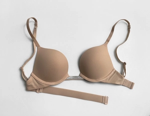 Detailed close-up of a nude push-up bra with rhinestone accents and seamless finish
