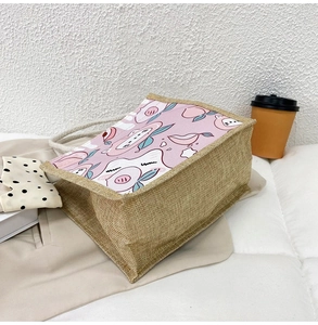 Detail of eco-friendly jute tote bag with cute cartoon peach and cotton rope handle