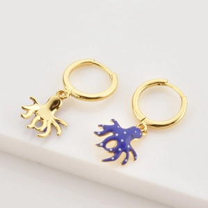 Detailed close-up of octopus earrings with blue enamel and golden finish hooks
