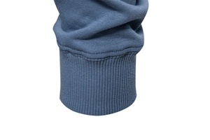 Detailed close-up of blue ribbed knit cuffs on a casual men's pullover sweatshirt