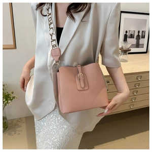 Pink lychee texture leather bucket bag featuring a trendy wide shoulder strap detail