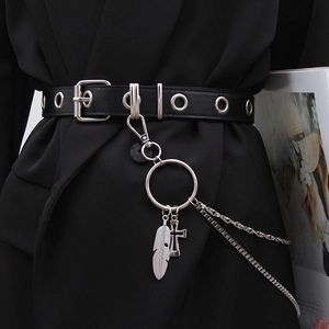 Detail of punk style black belt with silver eyelets, metal chains and feather charms