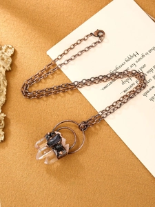 Detail view of vintage crystal pendant necklace with raw amethyst and hexagon prisms