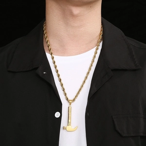 Close-up of a men's gold hammer pendant with twist chain on a model wearing casual clothes