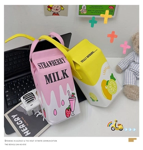 Macro view of strawberry and lemonade milk carton crossbody bags with shoulder straps