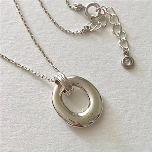 Macro shot of 925 sterling silver geometric oval pendant showing authentic hallmark