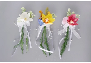 Three artificial orchid floral decorations for wine glasses in white, yellow, and rose red