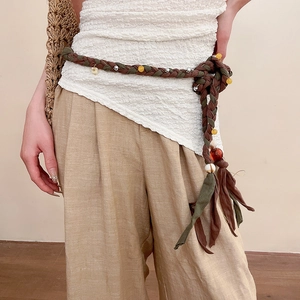 Detail of hand-woven ethnic waist chain with colorful crystal beads and tassels
