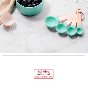 Close-up of copper plated stainless steel measuring spoons with mint green handles for baking