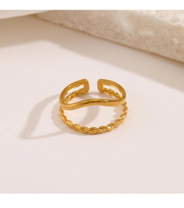 Detail of 18K gold plated double-layer wavy ring on minimalist stone background