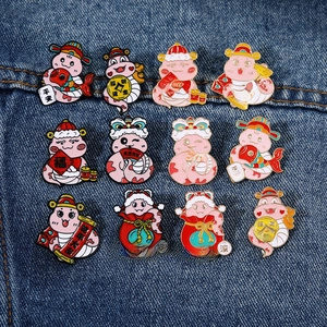 Detailed set of 12 cute Chinese Zodiac Year of the Snake enamel pins on denim background