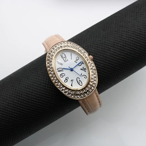 Close-up of elegant oval women's watch with rose gold diamond bezel and pink leather strap