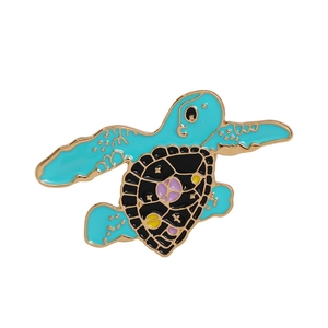 Cartoon turtle enamel pin with black shell and purple stars for clothes and bags