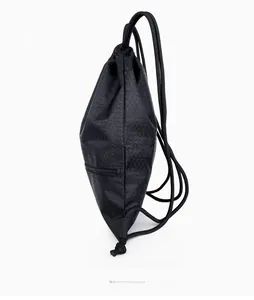 Side view of black nylon drawstring bag with hexagonal texture and hidden zipper pocket