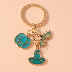 Close-up of Halloween keychain featuring enamel pumpkin, witch hat and bat charms