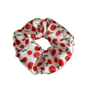Silk scrunchie with sweet cherry print made from pure mulberry silk on white background