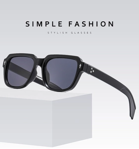Detail of square vintage sunglasses with black frame and silver decorative studs