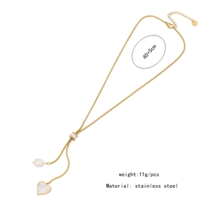 Detail of golden heart necklace with pearls and adjustable snake chain on white background