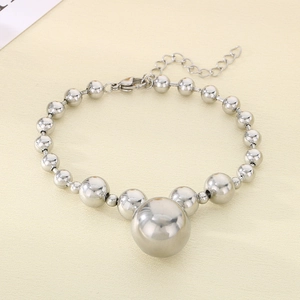 Detail of silver beaded bracelet with gradient metal spheres and lobster clasp closure