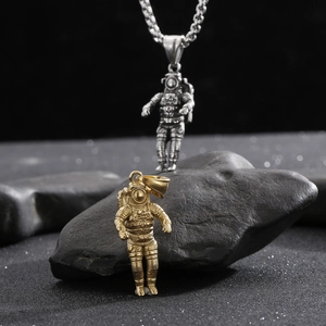 Detailed close-up of astronaut pendants in gold and silver finish with hip-hop chains