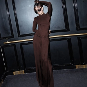 Detail of waist twist knot on a long-sleeved chocolate brown slim fit maxi dress