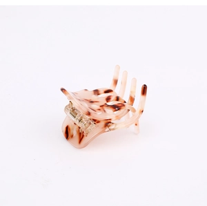 Detail of amber leopard print cellulose acetate hair claw clip with transparent spring