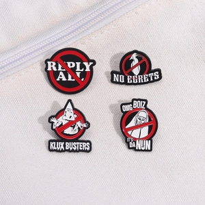 Set of four metal enamel pins featuring various graphic designs on a white canvas background