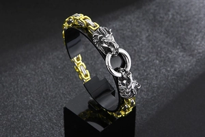Close-up of bicolor stainless steel lion head clasp on a heavy emperor chain bracelet