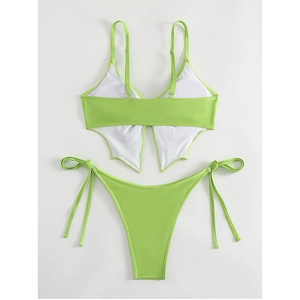 Detailed back view of neon green bikini top with unique butterfly wing cutout design