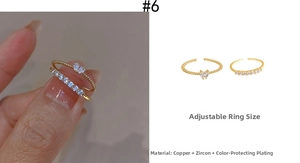 Detail showing two-piece gold ring set with heart zircon and adjustable open band design