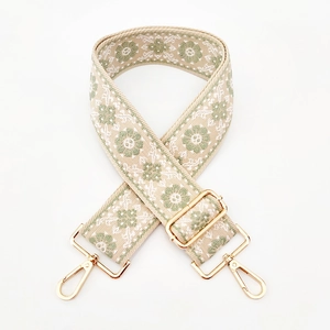 5cm wide embroidered floral purse strap with gold hardware on white background