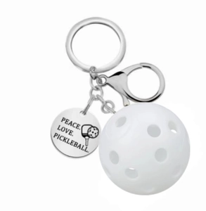 Detail of white pickleball keychain with engraved Peace Love Pickleball metal tag