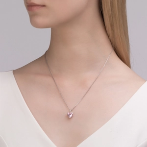 Close-up of S925 sterling silver heart necklace with pink zircon on a model's neck